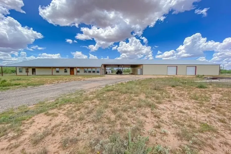 Front photo of the 12,000 sq ft structure, including 4800 sq ft Barndo, 2400sq ft Breezeway, and 4800 sq ft workshop. Car Port will fit 6 vehicles under it.