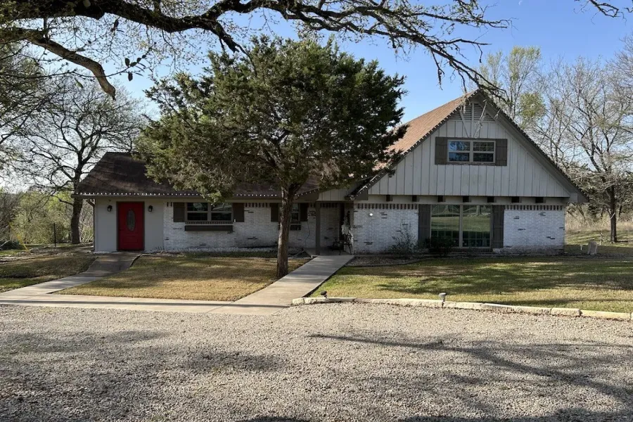 View of front of property featuring brick siding and a front yard