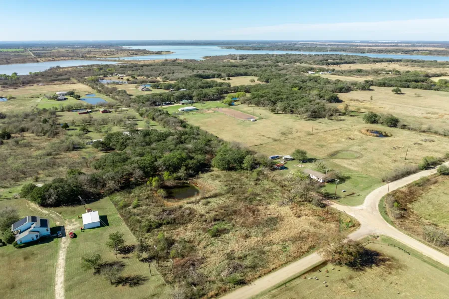 Aerial view of property's location with a large body of water