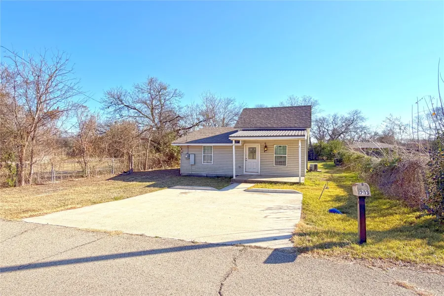 Bungalow-style house with a porch, a front lawn, and roof with shingles