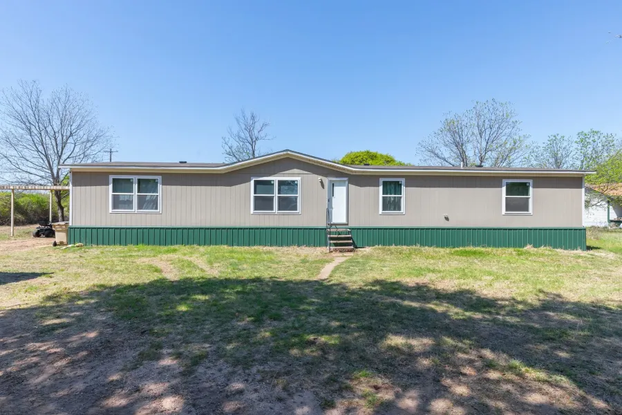 Manufactured / mobile home featuring a front lawn and entry steps