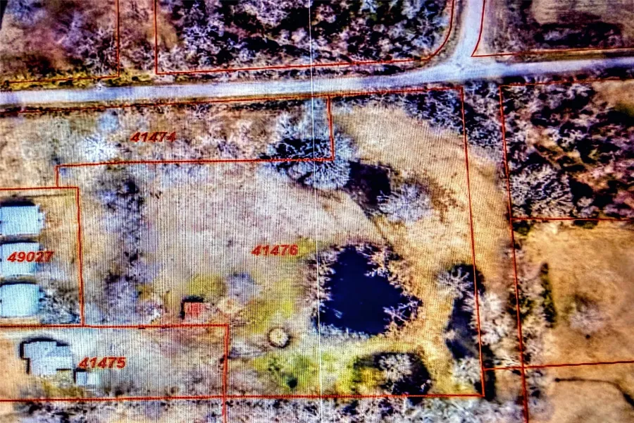 Aerial Property Map. Illustrating parcel boundaries and identifying various structures and water features on the property