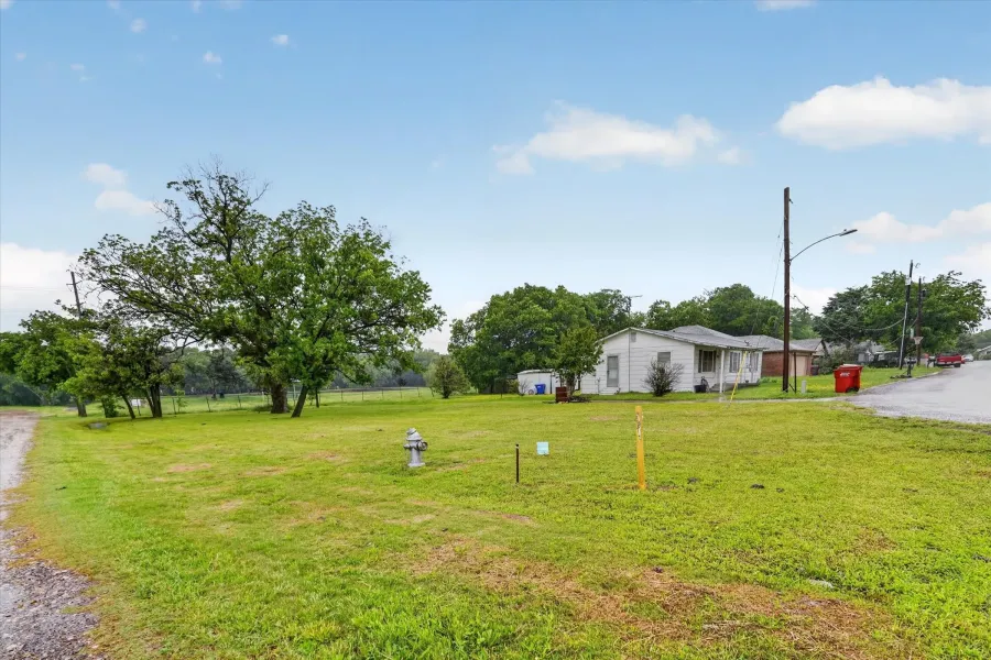 Expansive grassy parcel with mature trees and street frontage