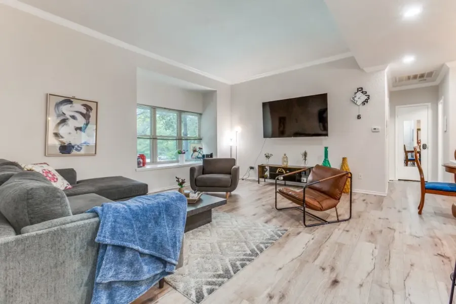 Living area featuring ornamental molding, light wood-style floors, and recessed lighting