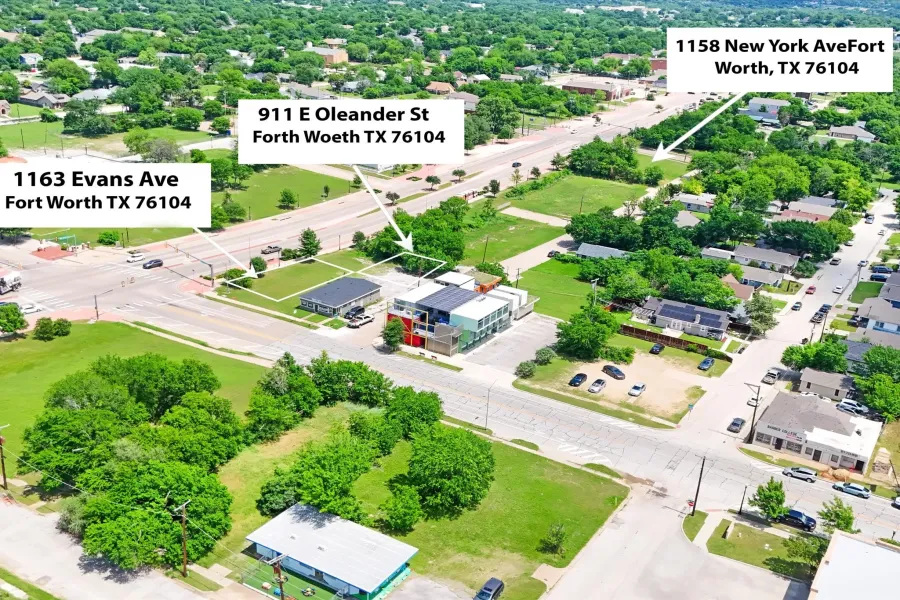 Aerial perspective showcasing multiple parcels, including a commercial building with modern facade elements and a flat roof