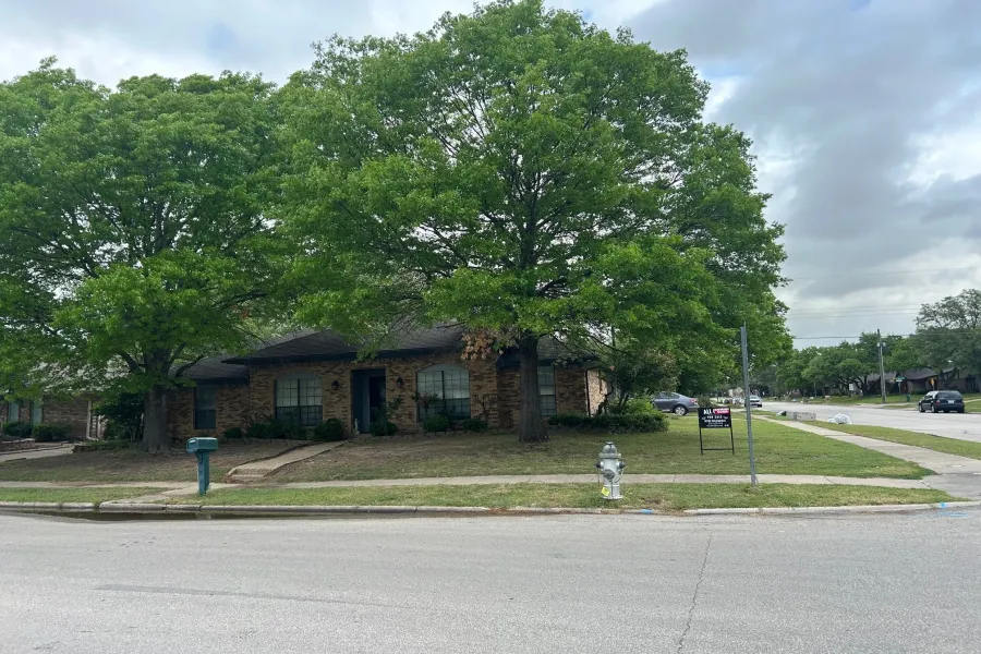 Single story home featuring a front lawn and brick siding
