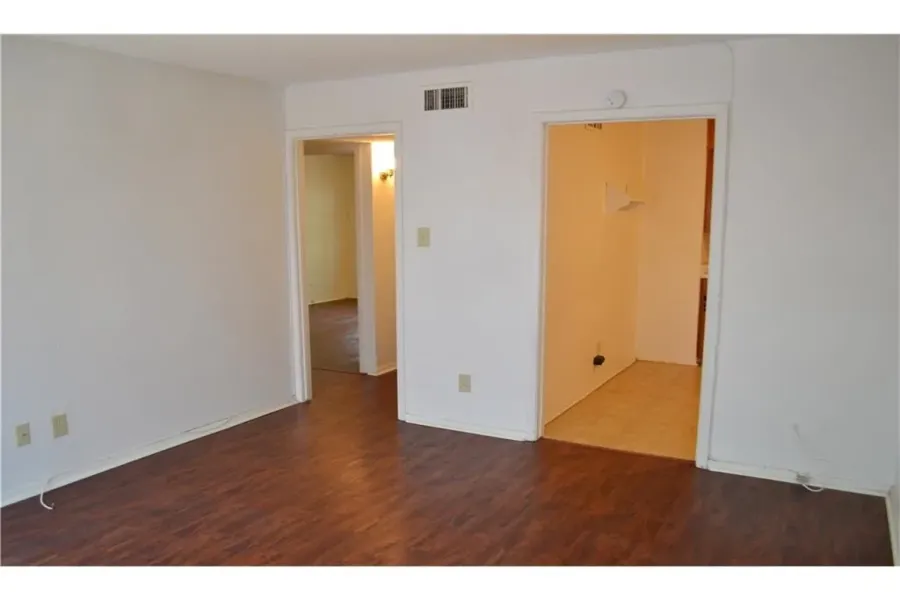 Inviting living area featuring beautiful wood-plank flooring and a bright, open layout.