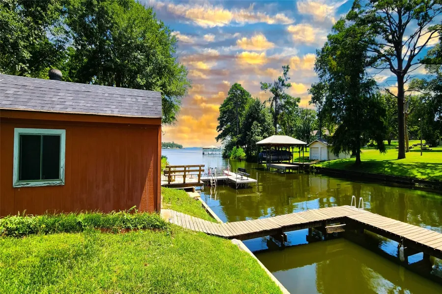 View of dock featuring a yard and a water view