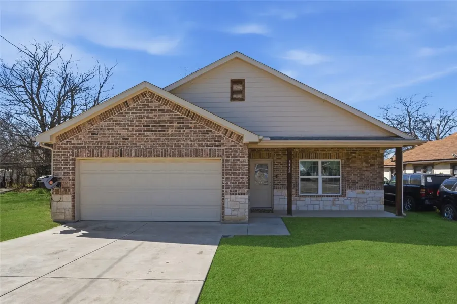 Brick and stone facade with an attached two-car garage