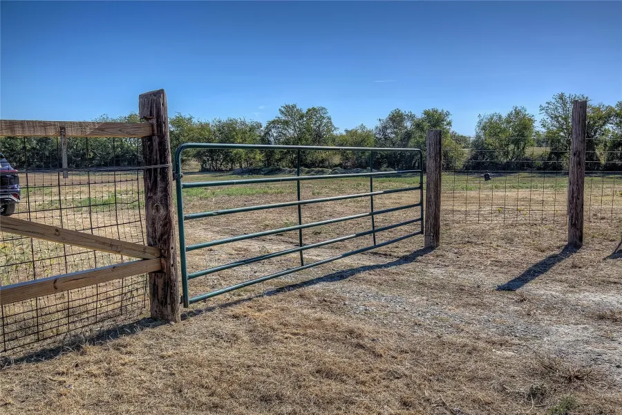 View of gate with a rural view