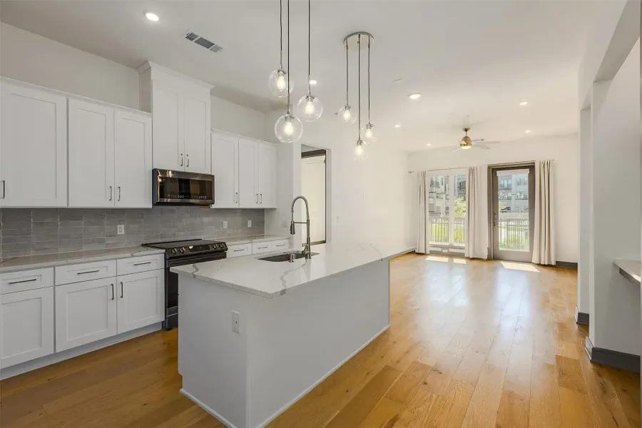 Open-concept living space with light wood-finish flooring