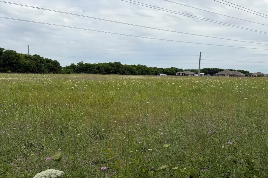 The track is shaped like an L.    The land goes behind the houses in the photo