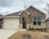 View of front of house featuring a garage, concrete driveway, and brick siding