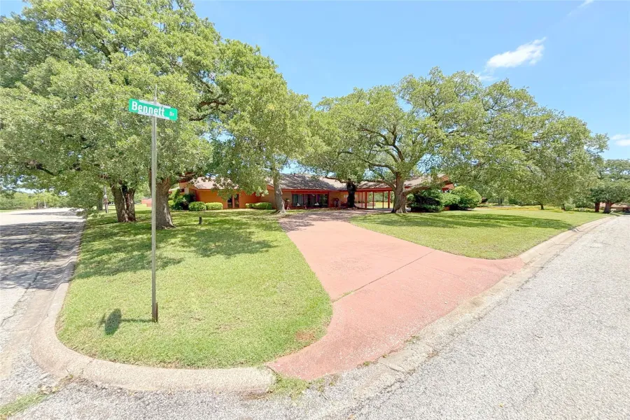 View of front of house with a front lawn and concrete driveway