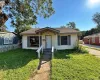 Bungalow-style house with roof with shingles and a front lawn