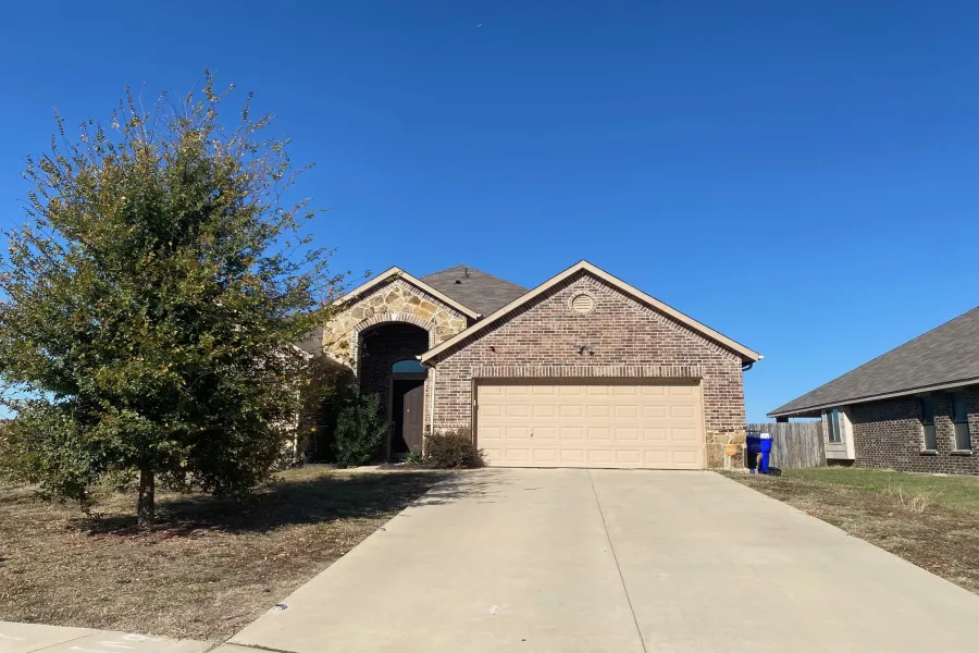 French provincial home featuring brick siding, concrete driveway, a garage, and stone siding
