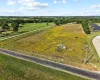 Aerial view of sparsely populated area with rows of crops
