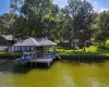 Dock area featuring boat lift, a water view, and stairway