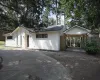 View of front of property with brick siding and a chimney