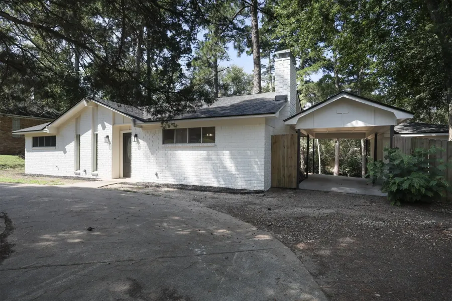 View of front of property with brick siding and a chimney