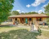Covered porch runs the full length of the house. Charming wooden bridge.