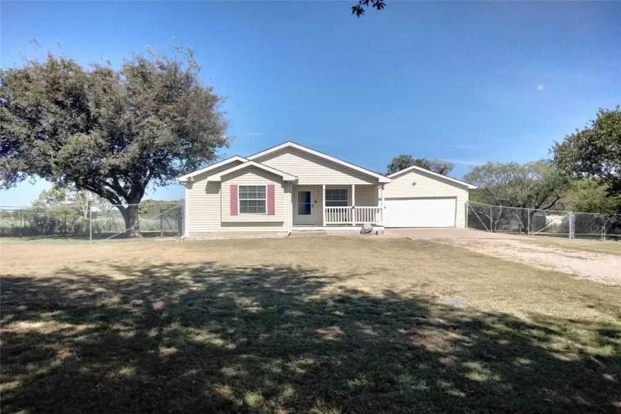 Single story home with driveway and nice porch.