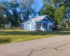 View of front of home featuring a porch, a front yard, and a metal roof