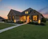 View of front facade with a front lawn, brick siding, and stone siding