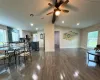 Dining space with dark wood-type flooring, ceiling fan, and vaulted ceiling