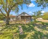 View of front of home featuring a wooden deck and a front lawn