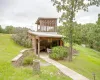 View of grassy yard featuring a gazebos (2)