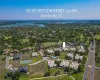 Aerial view of property's location featuring a nearby body of water and nearby suburban area