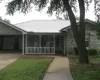 Ranch-style home featuring covered porch, concrete driveway, a metal roof, and an attached garage