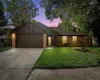 Ranch-style home featuring brick siding, a garage, concrete driveway, and a front lawn
