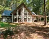 Back of house with a chimney and a pergola
