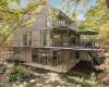 Modern Stucco home offering Industrial Chic features and with almost 4200 sq ft has numerous decks to enjoy the outside wooded acreage and floor to ceiling windows for stunning views