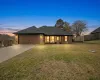 View of front facade featuring concrete driveway, brick siding, and a garage