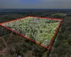 Aerial view of property's location featuring property boundaries highlighted and a heavily wooded area