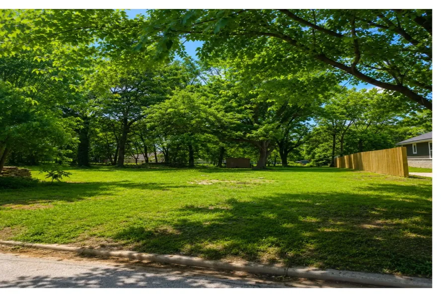 Expansive green lawn surrounded by mature trees